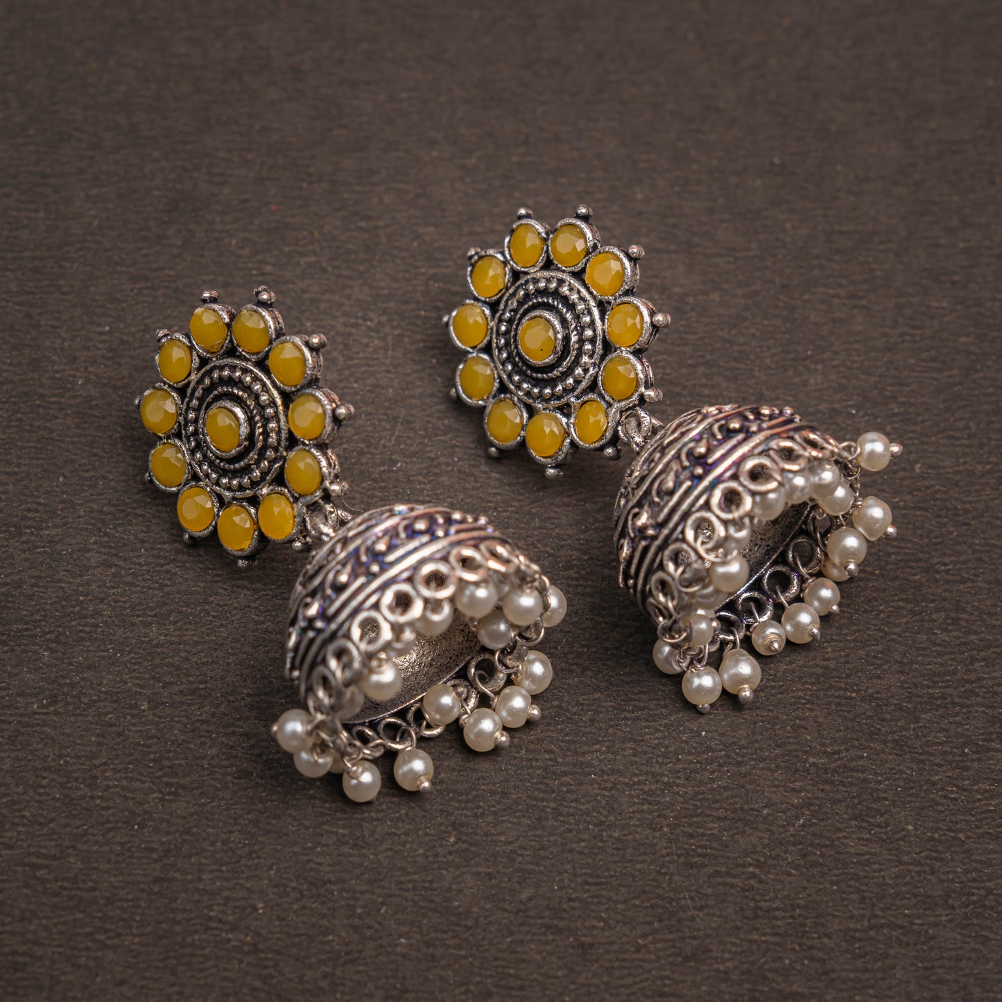 Yellow Stone Studded German Silver Jhumki Earrings With Hanging Pearls