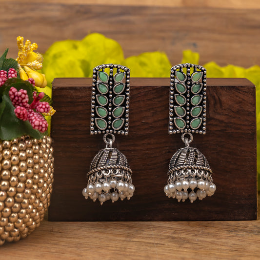 Pista Stone Studded German Silver Statement Earrings With Brass Jhumki